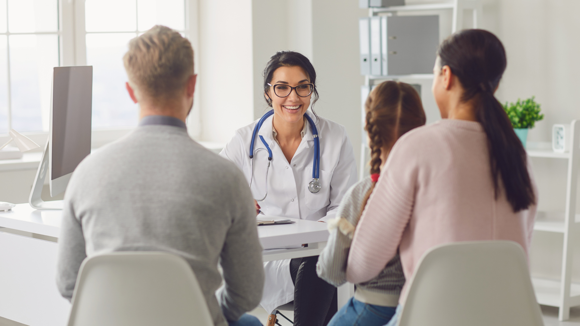 Man sitting on couch on video visit with his physician